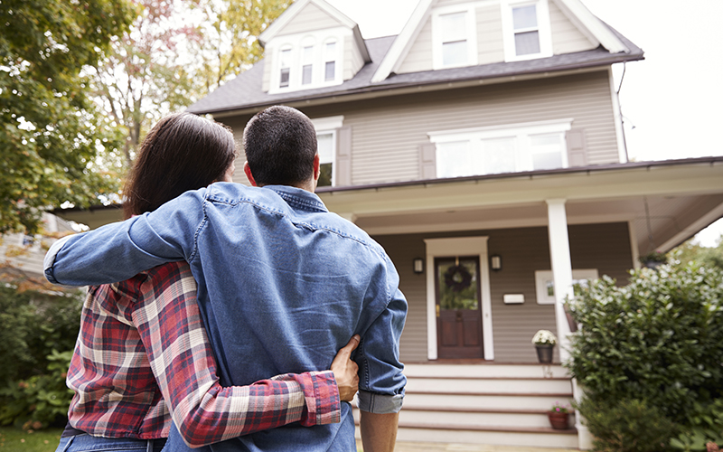 Rear View Of Loving Couple Looking At House Rear View Of Loving Couple Looking At House